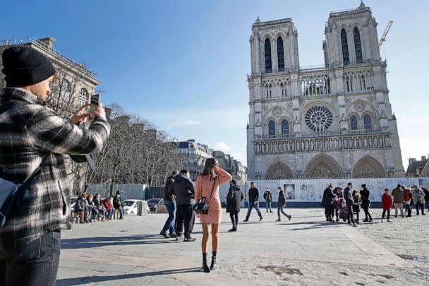 PHOTO: A woman poses in front of Notre-Dame de Paris Cathedral almost three years after fire ravaged the emblematic monument on Feb. 15, 2021 in Paris, France. (Chesnot/Getty Images, FILE)