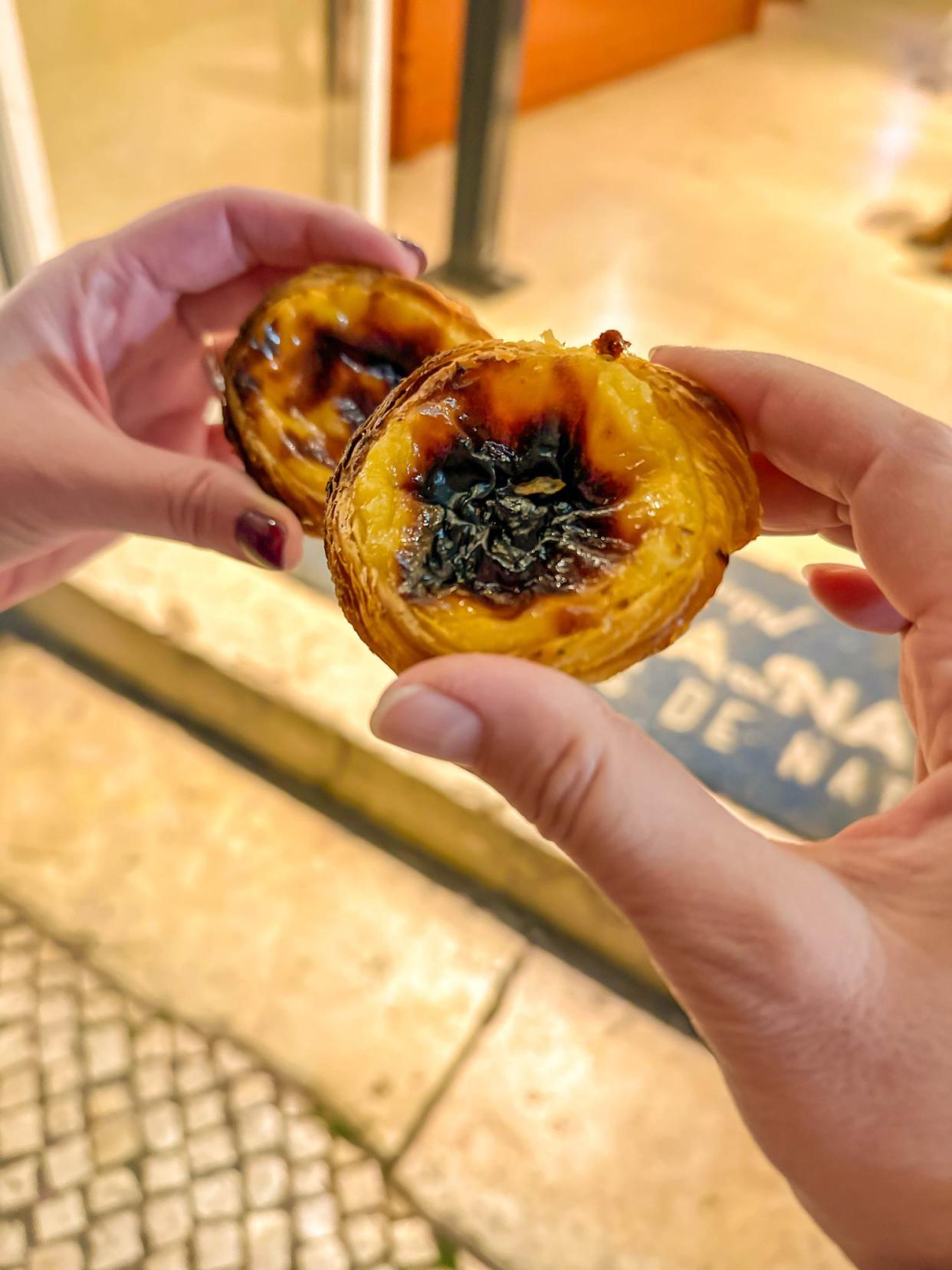 Two Female Hands Holding Pastéis de Nata Portugal