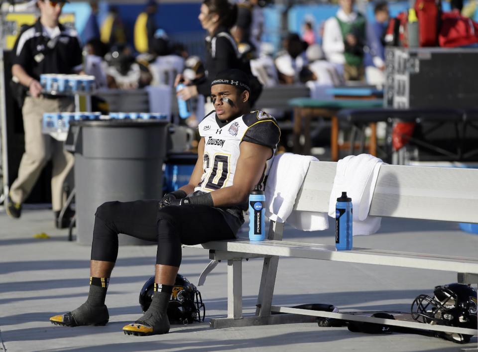 Towson wide receiver DeAngelo Stephenson (20) sits on the bench late in the second half of the FCS championship NCAA college football game against North Dakota State, Saturday, Jan. 4, 2014, in Frisco, Texas. NDSU won 35-7. (AP Photo/Tony Gutierrez)