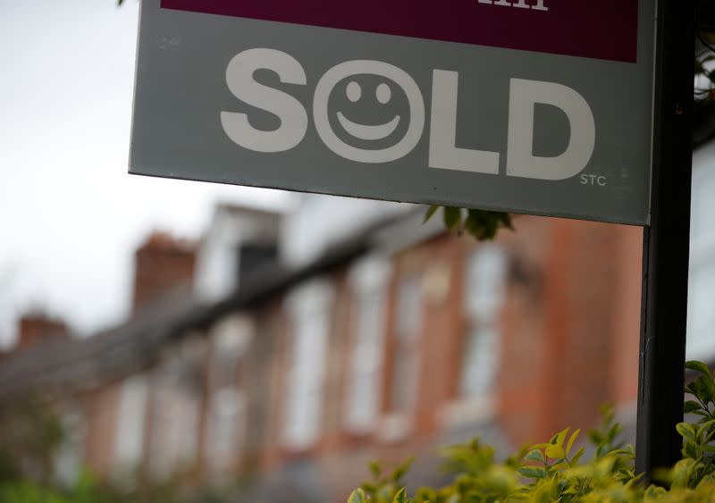 An estate agent’s board stands outside a housing development in Manchester