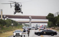 <p>Law enforcement officers from multiple Central Texas agencies respond to reports of an officer down in Round Rock, Texas, July 25, 2016. (Photo: Ricardo B. Brazziell/Austin American-Statesman/AP)</p>