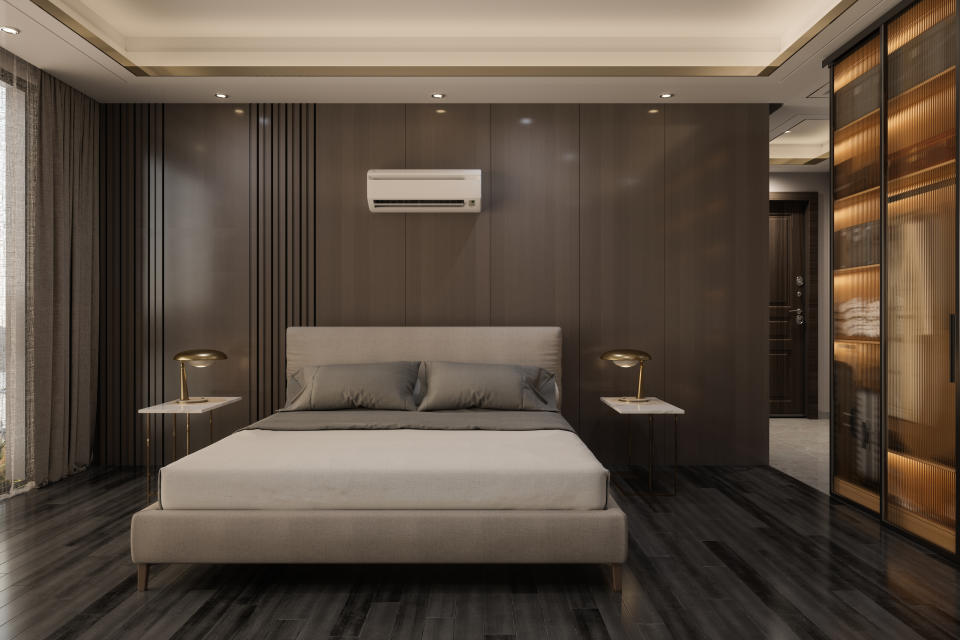 A modern bedroom suite with an aircon machine on the wall