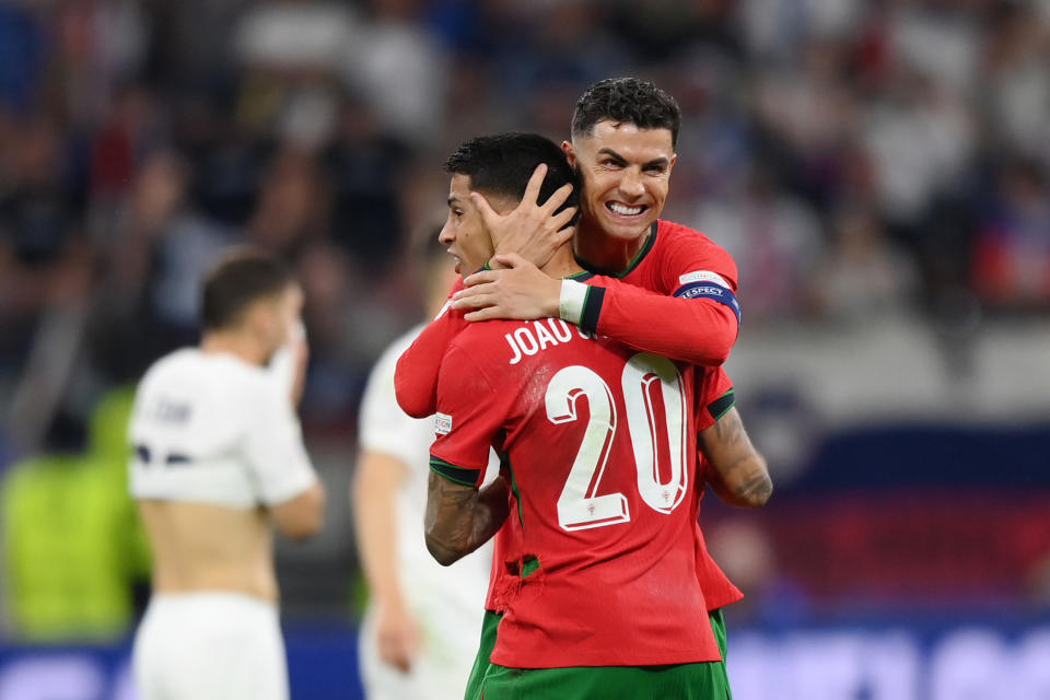 Cristiano Ronaldo and João Cancelo celebrate after the win. (Justin Setterfield/Getty Images)