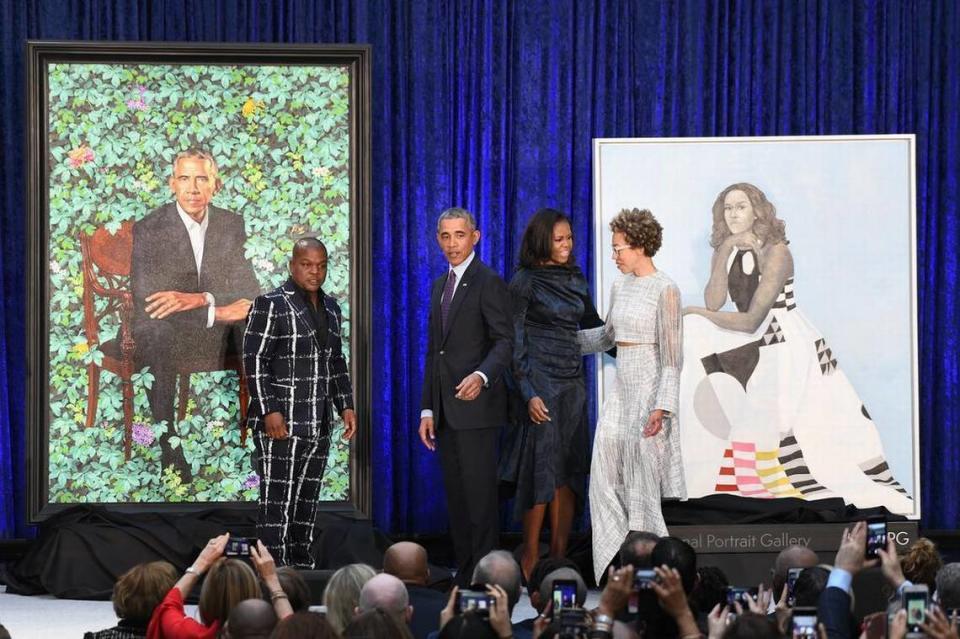 Former first lady Michelle Obama and former President Barack Obama pose with artists Kehinde Wiley and Amy Sherald during the unveiling of their official portraits at the National Portrait Gallery on February 12, 2018 in Washington, D.C.