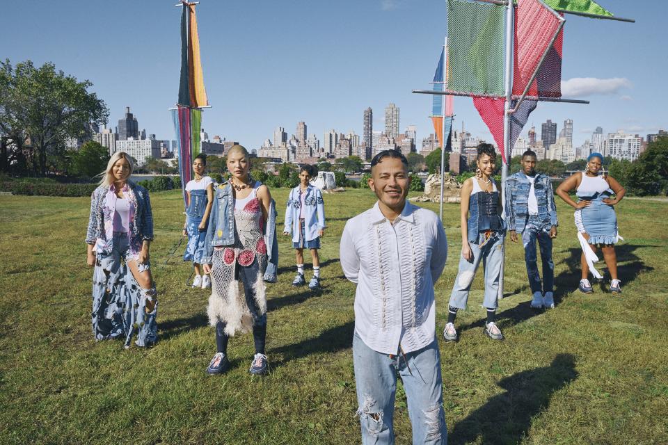 “I really think it’s coming from the madness of politics. As artists, our instinct is to reconnect with our communities.”—Rio Uribe
Uribe (center, in button-down shirt) and his community of models, activists, recording artists, DJs, and makeup artists in Socrates Sculpture Park, Queens. In this story: Hair: Recine for Rodin; Makeup: Jen Myles. Set Design: Andy Harman. Movement Direction: Celia Rawlson-Hall. Produced by PRODn at Art+Commerce.