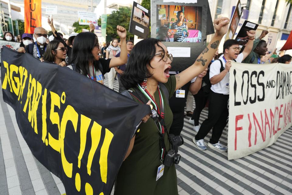 FILE - Activists demonstrate for climate justice and a ceasefire at the COP28 U.N. Climate Summit, Dec. 9, 2023, in Dubai, United Arab Emirates. (AP Photo/Peter Dejong, File)