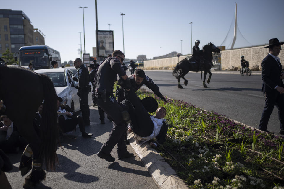 Israeli police officers disperse ultra-Orthodox Jewish men during a protest against army recruitment in Jerusalem, Sunday, June 2, 2024. Israel's Supreme Court is hearing the cases against the military enlistment exemptions of ultra-Orthodox Jewish men as the Israeli military's manpower has been strained by the nearly eight-month-long war against Hamas in Gaza. Its decision is expected in the coming weeks. (AP Photo/Leo Correa)