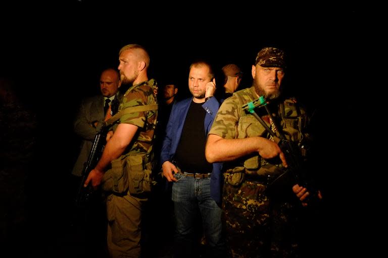 Self-proclaimed Prime Minister of the pro-Russian separatist "Donetsk People's Republic" Alexander Borodai (C) stands as he arrives on the site of the crash of a malaysian airliner carrying 298, in rebel-held east Ukraine, on July 17, 2014