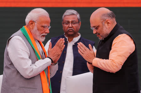 Prime Minister Narendra Modi and chief of the Bharatiya Janata Party (BJP) Amit Shah, greet each other before releasing their party's election manifesto for the general election in New Delhi, April 8, 2019. REUTERS/Adnan Abidi