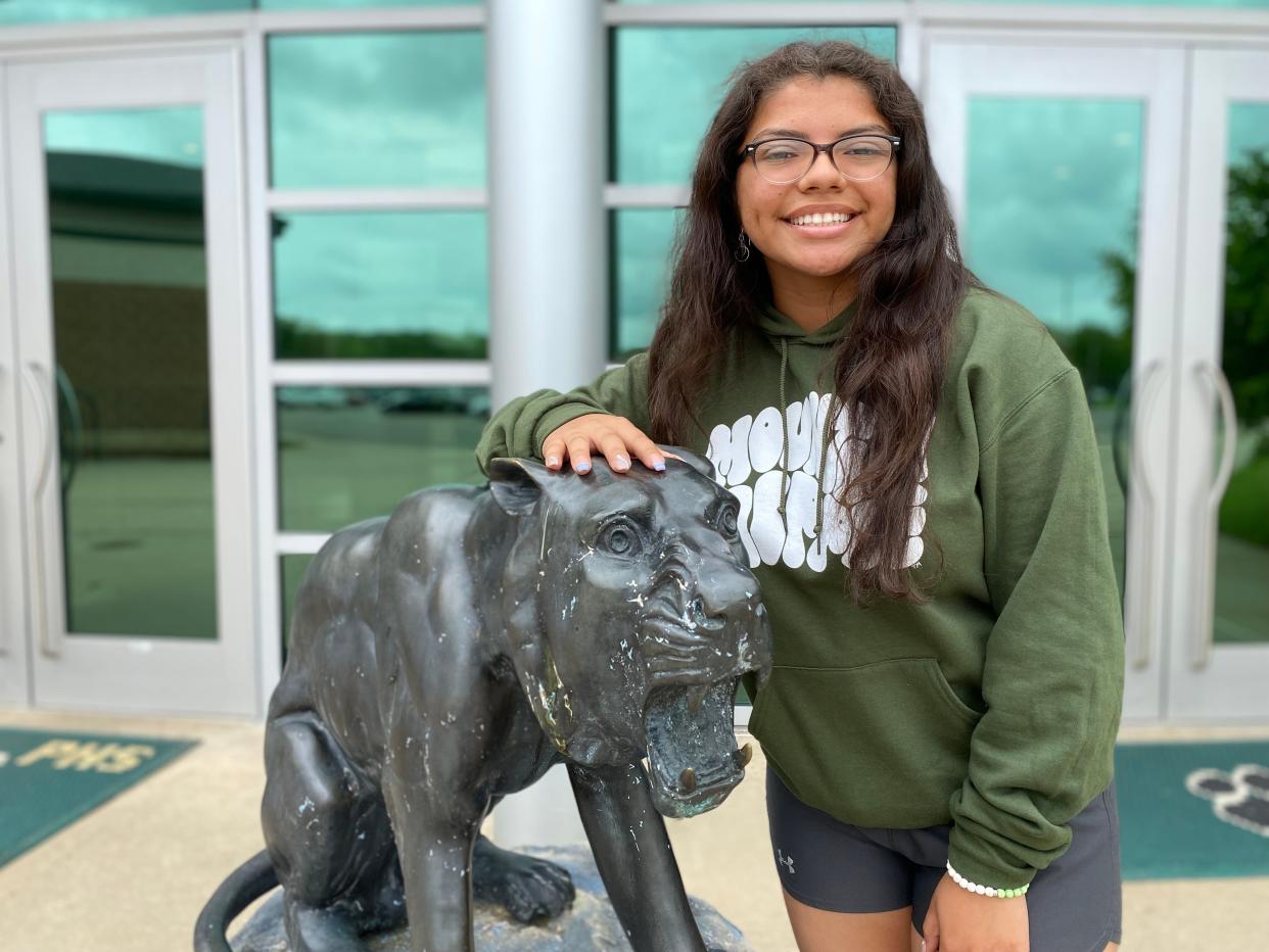 Andrea Bautista, a 2022 graduate of Pennfield High School, is pictured with the Panther statue outside the school on Thursday, May 26, 2022.