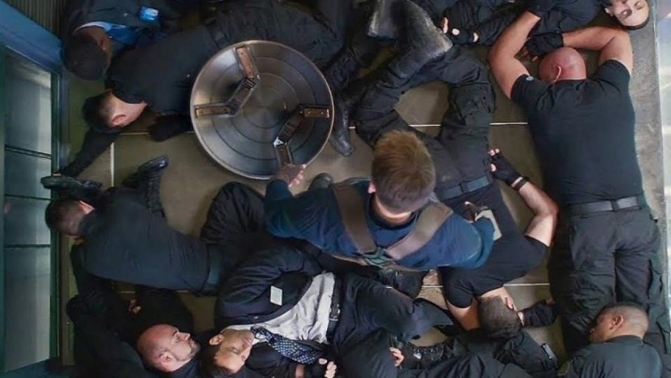 Captain America (Chris Evans) fights off Hydra agents in an elevator in Captain America: The Winter Soldier