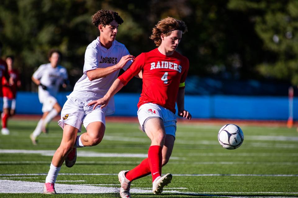 Red Hook's Carter Donohue, right, kicks the ball during the boys Section 9 Class B championship soccer game in Middletown on Saturday, October 29, 2022.