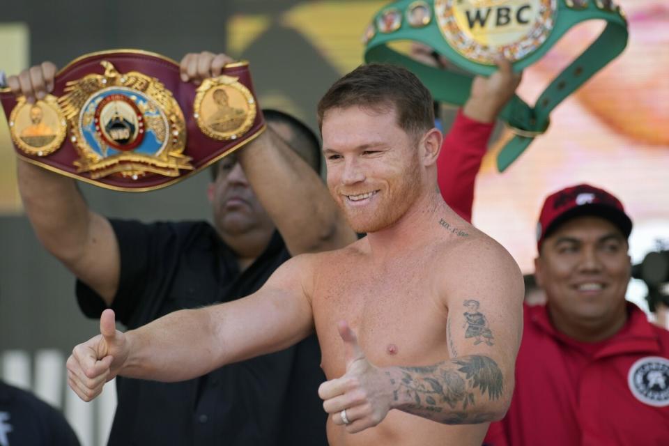 Canelo Álvarez motions to the crowd during a ceremonial boxing weigh-in Friday