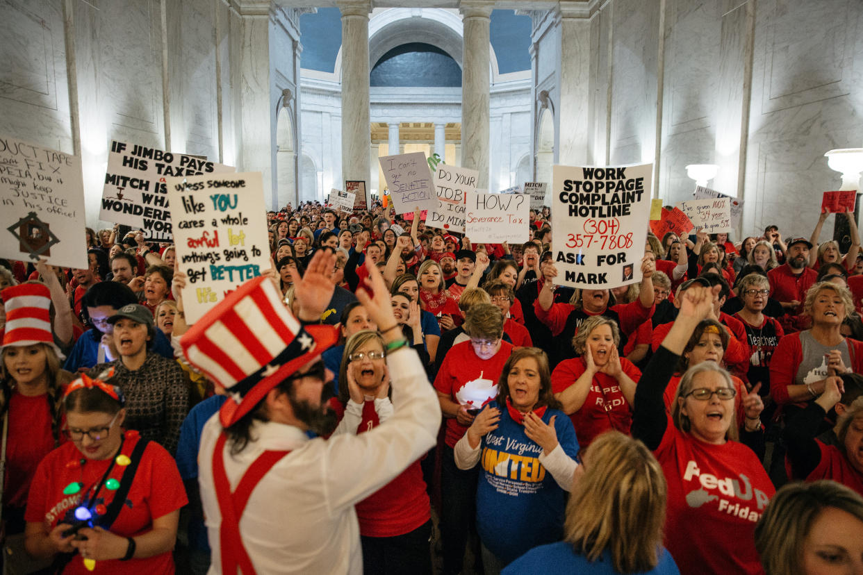 Striking school workers hold signs and chant inside the West Virginia Capitol in Charleston, March 2, 2018. (Photo: Scott Heins/Bloomberg via Getty Images)