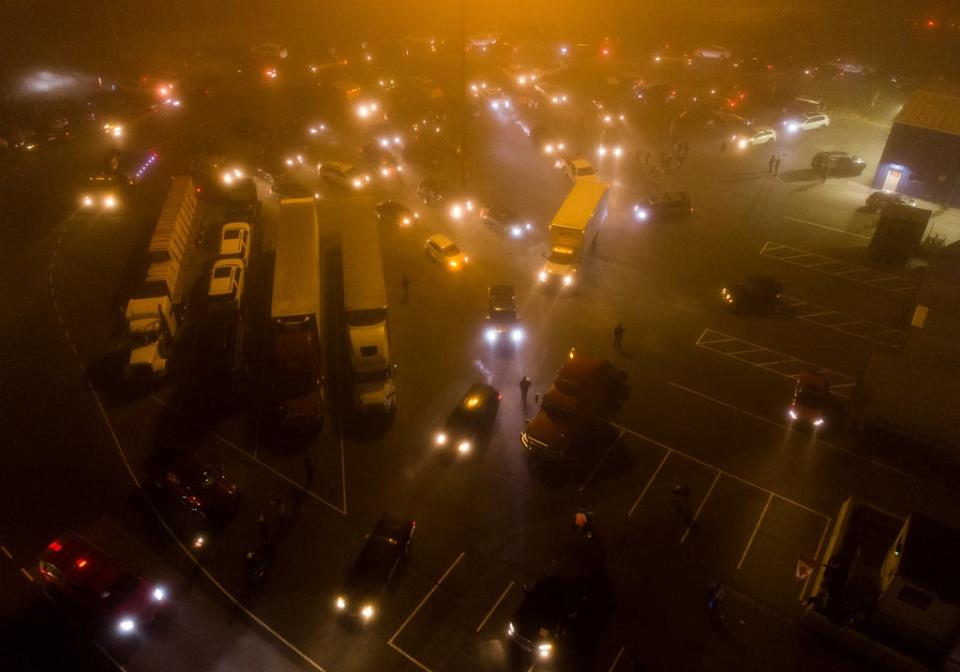 Truckers and supporters depart on a cross-country convoy destined for Ottawa to protest a federal vaccine mandate for truckers in Delta, B.C. on Sunday, January 23, 2022 (AP)