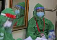 Health workers wait for patients during a mass test for the new coronavirus at the local district office in Tanah Abang in Jakarta, Indonesia, Sunday, June 21, 2020. (AP Photo/Dita Alangkara)