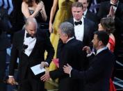 89th Academy Awards - Oscars Awards Show - Hollywood, California, U.S. - 26/02/17 - Martha Ruiz (R, in red) and Brian Cullinan (upper R) of PricewaterhouseCoopers confer on stage after the Best Picture was mistakenly awarded to "La La Land" instead of "Moonlight". REUTERS/Lucy Nicholson/Files