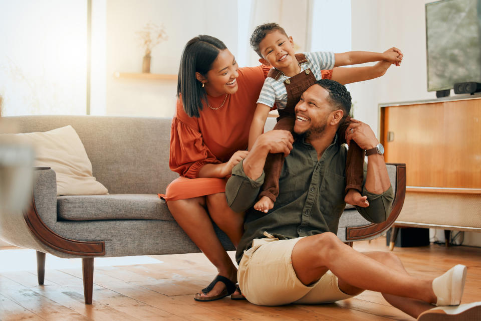 Family with a child on father's shoulders enjoying time together indoors