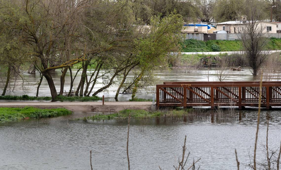 The Tuolumne River passes through Tuolumne Regional Park near the Highway 99 overcrossing in Modesto, Calif., Tuesday, March 21, 2023.