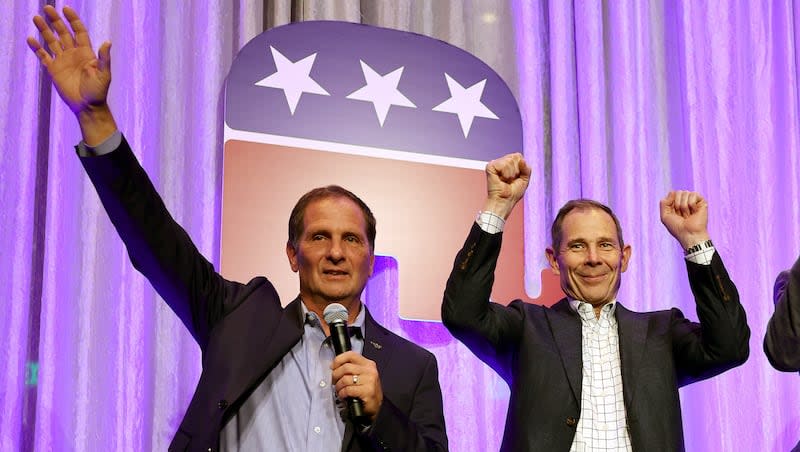 Rep. John Curtis, R-Utah and Rep. Chris Stewart, R-Utah, take the stage at an election party at the Hyatt Regency in Salt Lake City on Tuesday, Nov. 8, 2022.