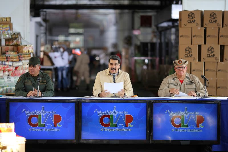 FILE PHOTO: Venezuela's President Nicolas Maduro along with Venezuela's Defense Minister Padrino Lopez, delivers a speech, in Caracas