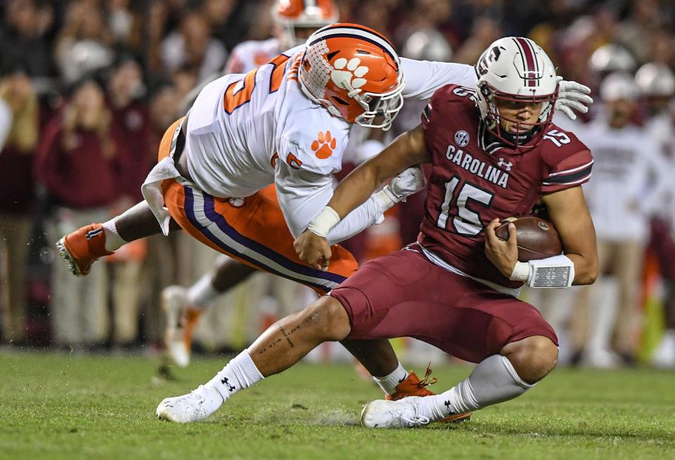 Clemson defensive end K.J. Henry (5) sacks South Carolina quarterback Jason Brown (15) during the first quarter at Williams Brice Stadium in Columbia, South Carolina Saturday, November 27, 2021.