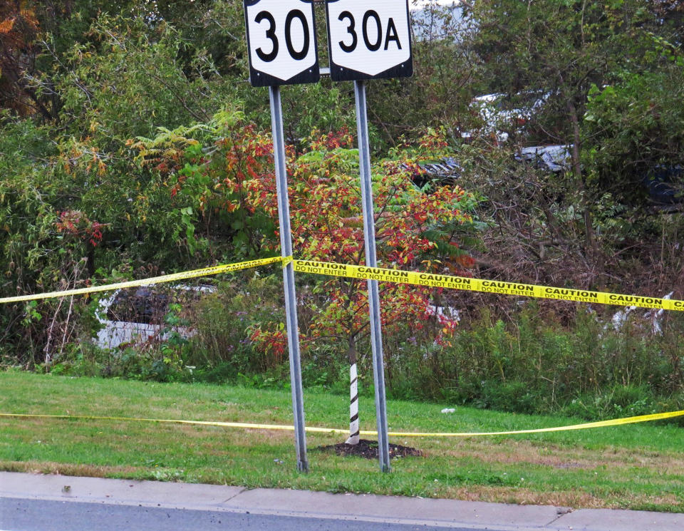 In this Saturday, Oct. 6, 2018 photo, a limousine, left, has landed in the woods following a fatal crash in Schoharie, N.Y. (Tom Heffernan Sr. via AP)