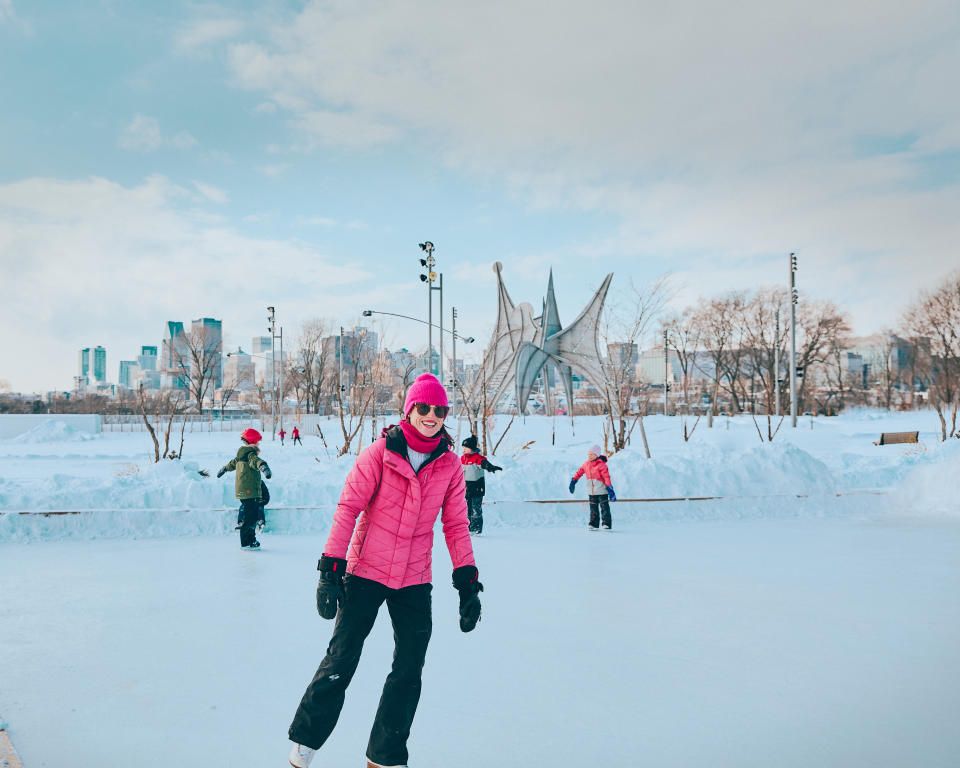 Mother ice skating with children at Parc Jean-Drapeau in Montreal