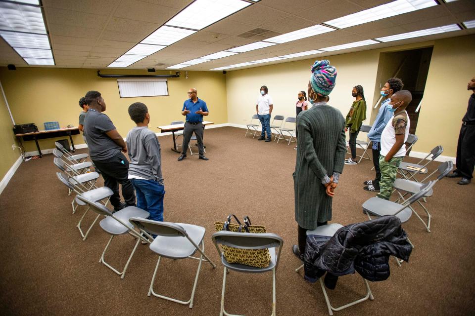 William Douglas works with students in an etiquette class for the Gentlemen and Scholars group Thursday, Jan. 13, 2022, at the IMPower Center in South Bend.