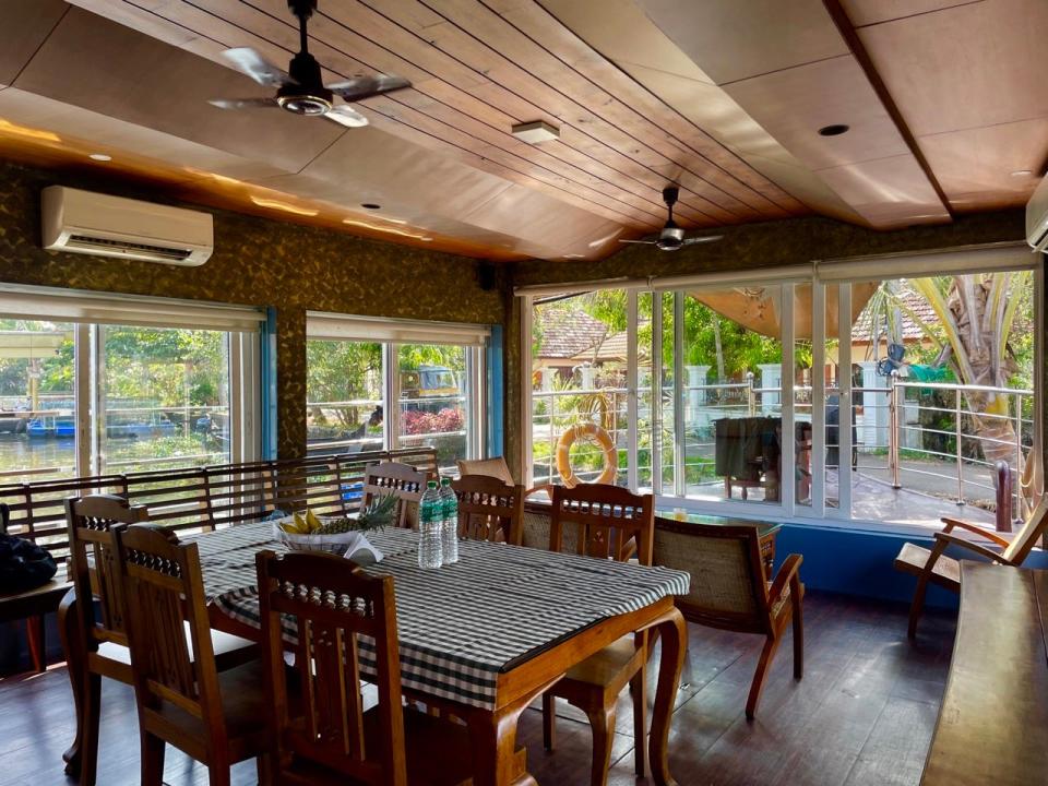 Gingham-clothed table in dining area of house boat 