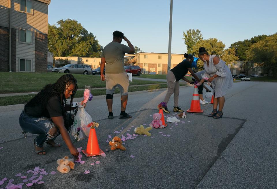 FILE - Cori Bush, left, drops paper rose petals around a memorial to Michael Brown on Canfield Drive in Ferguson, Mo., as she and others members of the community rebuild the memorial where Brown was shot and killed by Ferguson Police officer Darren Wilson, on Aug. 7, 2019. Democratic U.S. Rep. Cori Bush wrote on Facebook and Twitter that protesters in Ferguson, Missouri, in 2014, were shot at by white supremacists, even though Ferguson's police chief said he was unaware of any such incident. (David Carson/St. Louis Post-Dispatch via AP File)