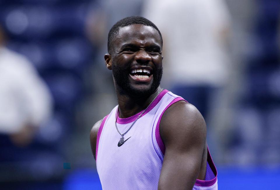 Frances Tiafoe smiles as he celebrates his win against Bulgaria’s Grigor Dimitrov who retired due to injury during their men’s quarterfinals match (AFP via Getty Images)