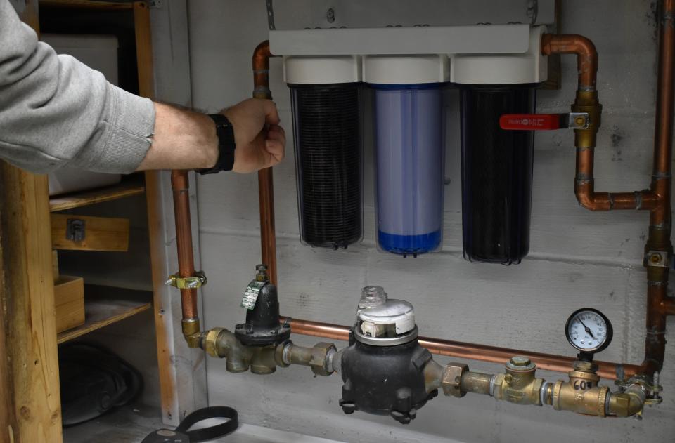 David Butts, of Industry, has spent hundreds of dollars maintaining the new water filtration system in his home. Without it, black, sediment-laced water pours from his faucets.