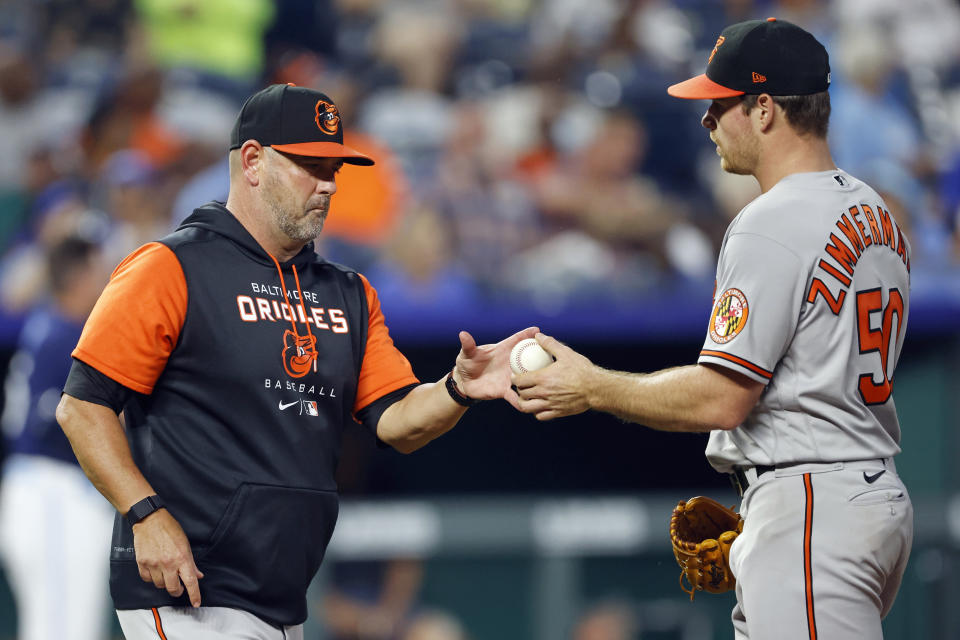 Baltimore Orioles manager Brandon Hyde, left, takes the ball from pitcher Bruce Zimmermann (50) as Zimmermann is taken out during the fifth inning of a baseball game against the Kansas City Royals in Kansas City, Mo., Friday, June 10, 2022. (AP Photo/Colin E. Braley)