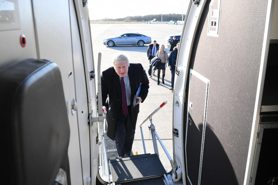 Prime Minister Boris Johnson boards his plane, following a visit to a Grimsby Fish Market, as he heads north to Teesside for the next stop on the General Election campaign trail.