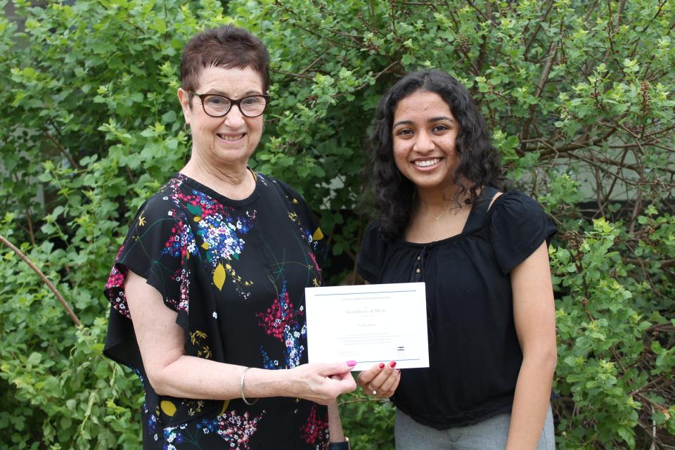 (Left to right) SCVTHS Supervisor of Academics Teresa Morelli presents SCVTHS senior Academy for Health and Medical Sciences student Nidhi Shah of Hillsborough with her Certificate of Merit for being named a National Merit® Scholarship program finalist.