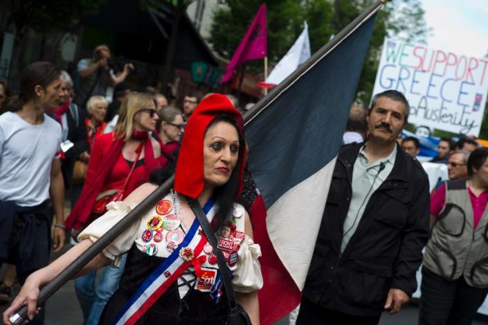 A woman dressed as a French 1789 revolutionary takes part in a demonstration in support of both migrants and the Greek people on June 20, 2015 in Paris (AFP Photo/Kenzo Tribouillard)