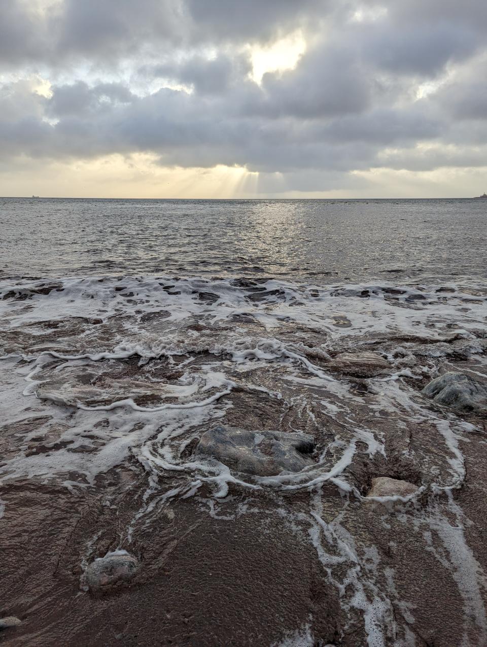 Sunrise beach with long exposure effect blurring the ocean water movement