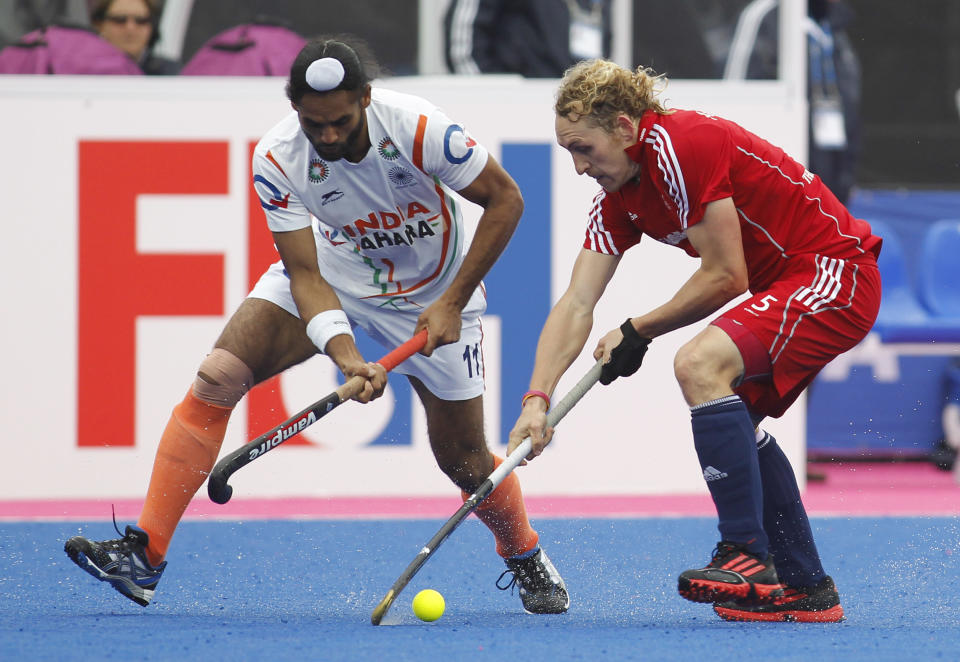 Britain's Richard Alexander, right, competes with India's Sarvanjit Singh during the men's bronze medal field hockey match between Britain and India at the Riverbank field hockey arena in the Olympic Park in London, Sunday, May 6, 2012. (AP Photo/Sang Tan)