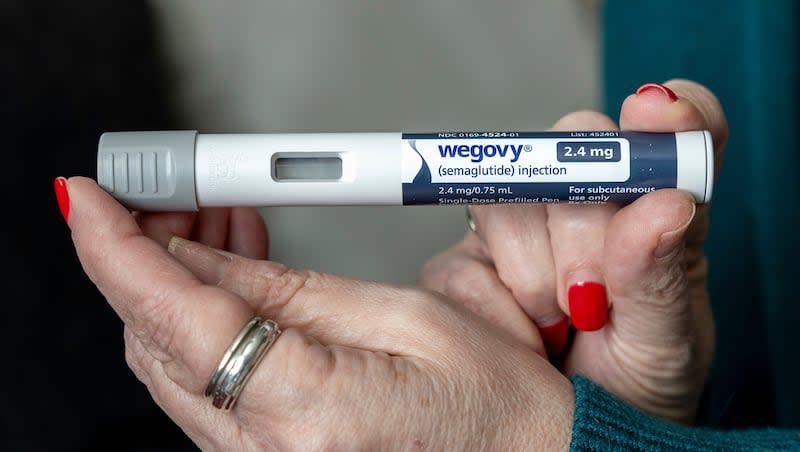 Donna Cooper holds up a dosage of Wegovy, a drug used for weight loss, at her home in Front Royal, Va., on Friday, March 1, 2024. "To me, it's a help, it's an aid," says Cooper, 62, who lost nearly 40 pounds in nine months using Wegovy along with diet and exercise. "At some point you have to come off of them. I don't want to be on them forever."