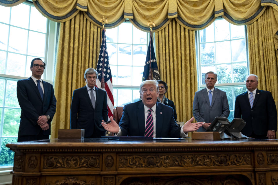 WASHINGTON, DC - APRIL 24: U.S. President Donald Trump participates in a signing ceremony for H.R.266, the Paycheck Protection Program and Health Care Enhancement Act, with members of his administration and Republican lawmakers in the Oval Office of the White House in Washington DC on April 24th, 2020. The bill includes an additional $321 billion for the Paycheck Protection Programs forgivable loans to cover payroll and other costs for small businesses. Hospitals and other health care providers will receive $75 billion and another $25 billion is allocated for COVID-19 testing. (Photo by Anna Moneymaker/The New York Times/POOL/Getty Images)