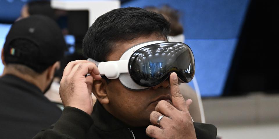 Man tries on Apple Vision Pro at an Apple Store