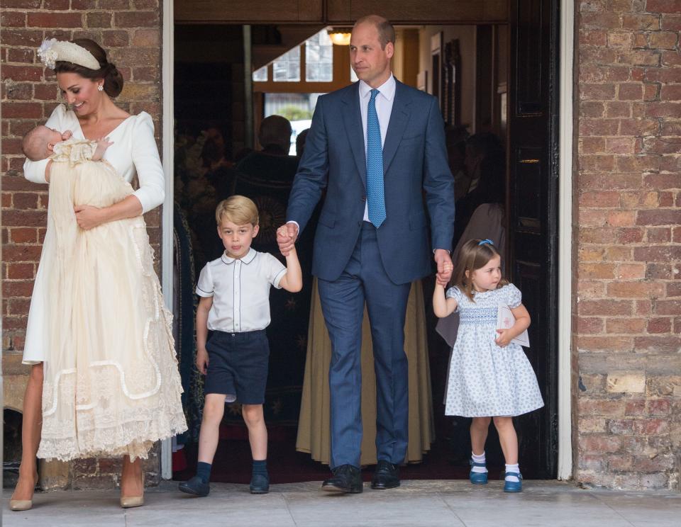 Princess Charlotte of Cambridge and Britain's Prince George of Cambridge hold hands with their father, Britain's Prince William, Duke of Cambridge, as Britain's Prince Louis of Cambridge is carried by his mother, Britain's Catherine, Duchess of Cambridge after his christening service at the Chapel Royal, St James's Palace, London on July 9, 2018. (Photo by Dominic Lipinski / POOL / AFP)        (Photo credit should read DOMINIC LIPINSKI/AFP/Getty Images)