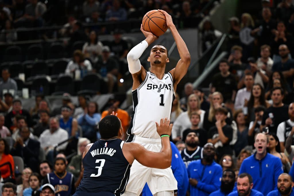  San Antonio Spurs' French forward-center #01 Victor Wembanyama shoots the ball past Dallas Mavericks' US power forward #03 Grant Williams during the NBA basketball game between the Dallas Mavericks and the San Antonio Spurs at the AT&T Center in San Antonio, Texas on October 25, 2023. 