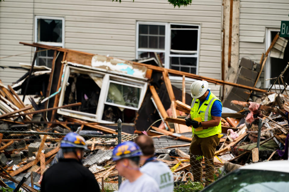 Investigators and utility crews work the scene of a deadly explosion in a residential neighborhood in Pottstown, Pa., Friday, May 27, 2022. A house exploded northwest of Philadelphia, killing several people and leaving others injured, authorities said Friday. (AP Photo/Matt Rourke)