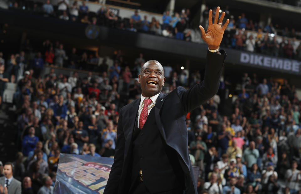 Retired Denver Nuggets center Dikembe Mutombo waves to the crowd as his jersey number was retired by the team during halftime of the Nuggets' NBA basketball game against the Portland Trail Blazers on Saturday, Oct. 29, 2016, in Denver. Portland won 115-113 in overtime. (AP Photo/David Zalubowski)