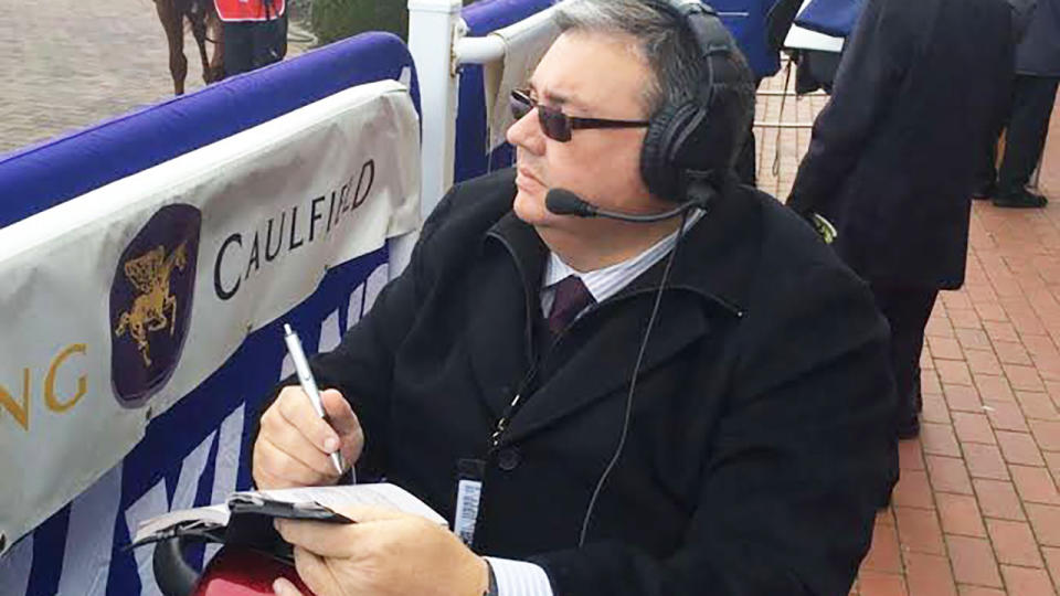 Deane Lester looks on while broadcasting from Caulfield Racecourse.