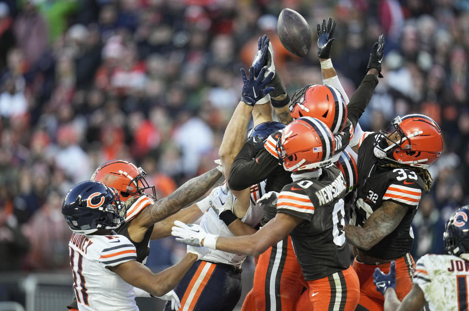 A number of players go up for a Hail Mary pass at the end of the game, including Chicago Bears' Darnell Mooney (11), Cleveland Browns' Greg Newsome II (0) and Ronnie Hickman, in an NFL football game, Sunday, Dec. 17, 2023, in Cleveland. (AP Photo/Sue Ogrocki)