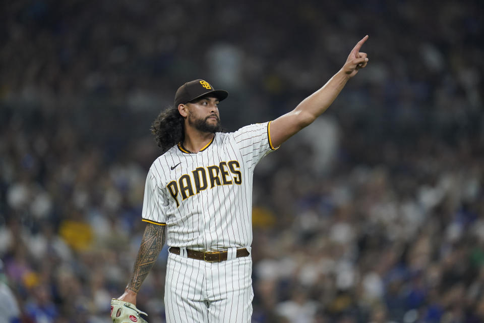 San Diego Padres starting pitcher Sean Manaea gestures toward right fielder Juan Soto after Los Angeles Dodgers' Chris Taylor lined out to Soto during the fourth inning of a baseball game Thursday, Sept. 29, 2022, in San Diego. (AP Photo/Gregory Bull)