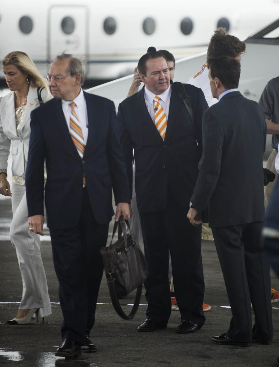 Tennessee men's basketball coach Donnie Tyndall, center, talks to athletic director Dave Hart after Tyndall arrived Tuesday, April 22, 2014, in Knoxville, Tenn. At left are Tyndall's fiancee, Nikki Young, and Tennessee chancellor Jimmy Cheek. The former Southern Mississippi coach succeeds Cuonzo Martin, who resigned last week to take the coaching job at California. (AP Photo/Knoxville News Sentinel, Paul Efird)